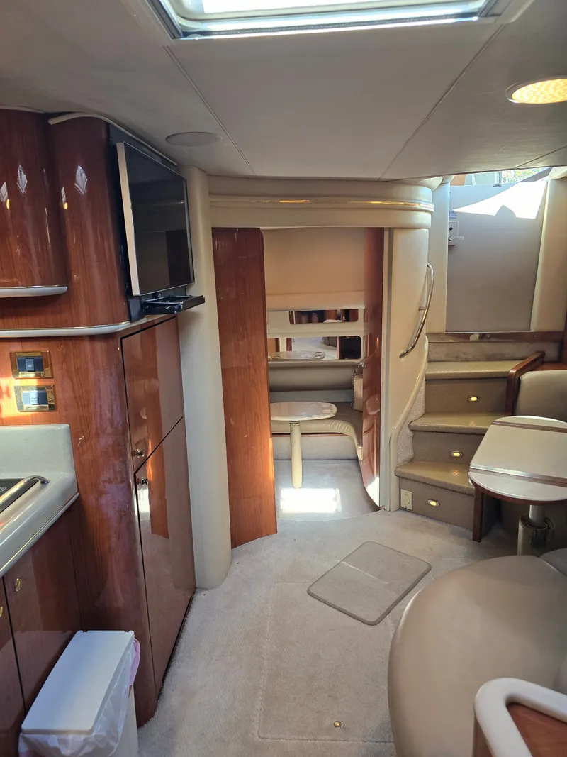 Slide: The Image of Interior of a 1998 Sea Ray 450 Sundancer yacht with luxurious design. - 12