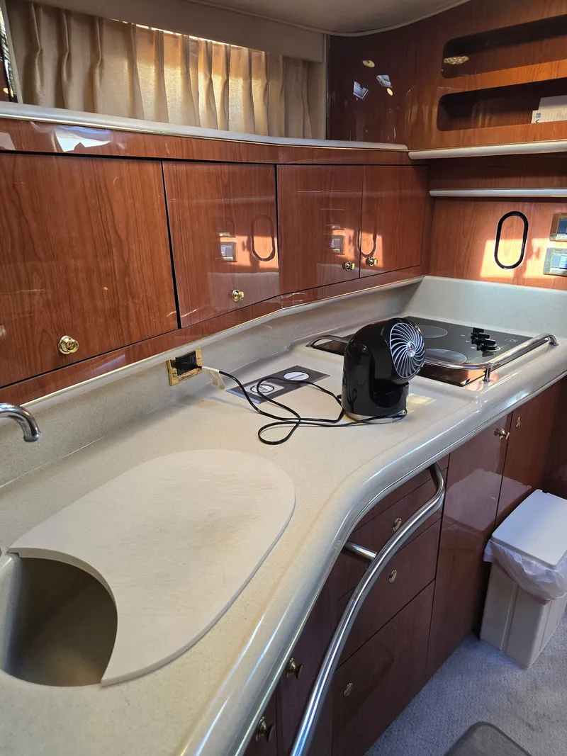 Slide: The Image of Interior of 1998 Sea Ray 450 Sundancer yacht kitchen area. - 14