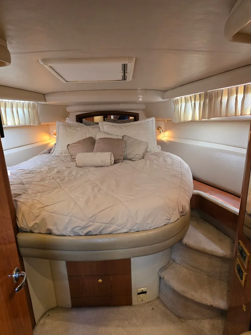 Slide: The Image of Luxurious cabin of 1998 Sea Ray 450 Sundancer with cozy bed. - 16