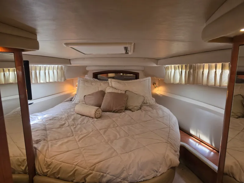 Slide: The Image of Luxurious bedroom in a 1998 Sea Ray 450 Sundancer yacht. - 17