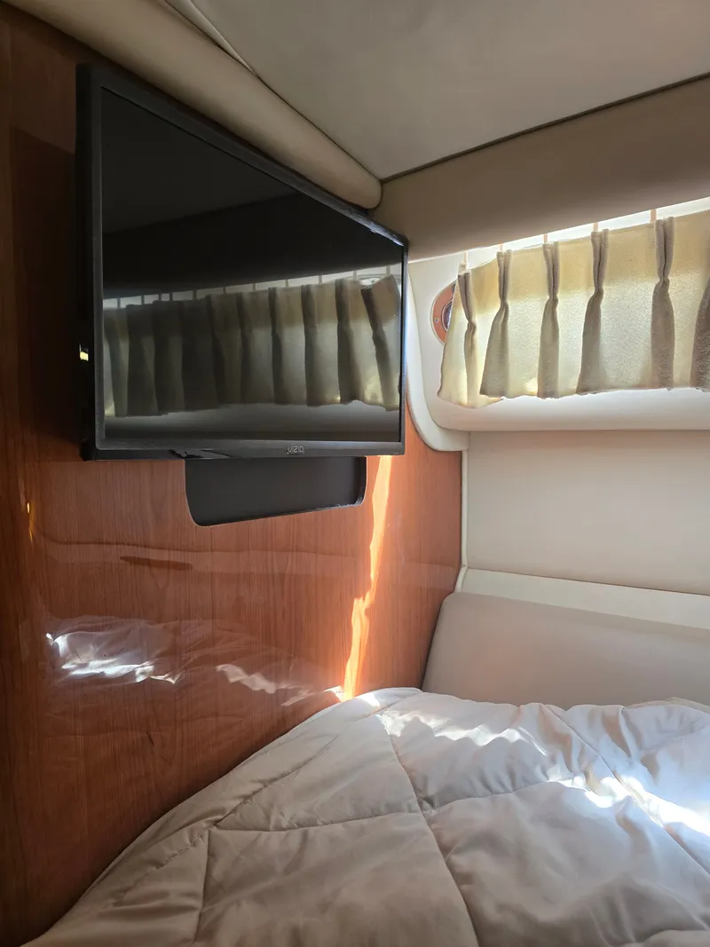 Slide: The Image of Interior of 1998 Sea Ray 450 Sundancer with TV and bed. - 18