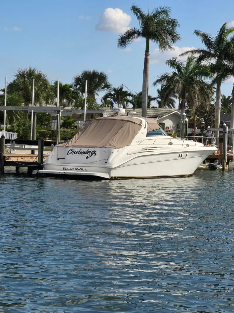 Slide: The Image of 1998 Sea Ray 450 Sundancer yacht docked with palm trees. - 2
