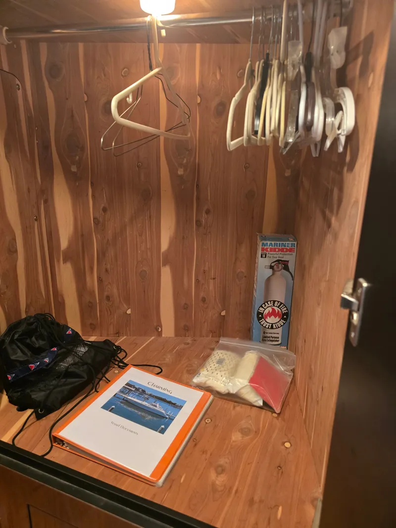 Slide: The Image of Interior of 1998 Sea Ray 450 Sundancer with hangers and manual. - 20