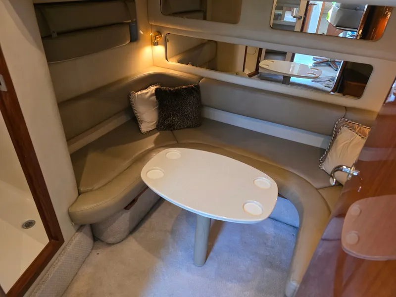 Slide: The Image of Interior of 1998 Sea Ray 450 Sundancer with cozy seating area. - 22