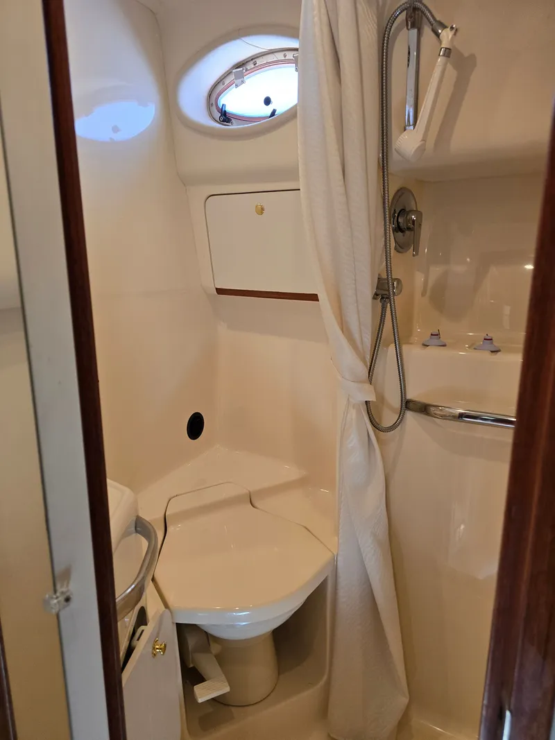 Slide: The Image of 1998 Sea Ray 450 Sundancer bathroom with shower and toilet. - 23