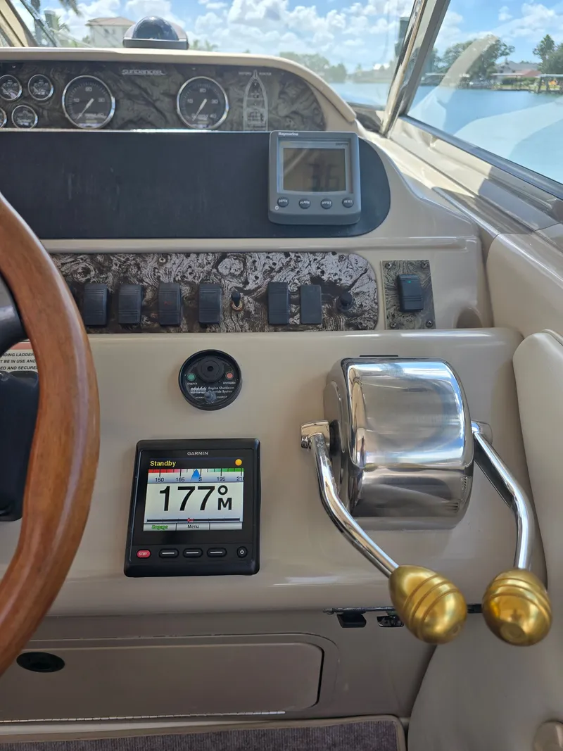 Slide: The Image of 1998 Sea Ray 450 Sundancer dashboard with controls and instruments. - 25