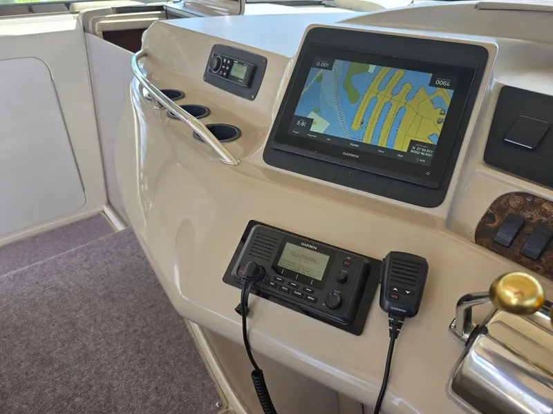Slide: The Image of 1998 Sea Ray 450 Sundancer dashboard with Garmin navigation system. - 26