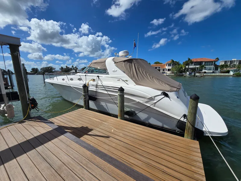 Slide: The Image of 1998 Sea Ray 450 Sundancer docked under sunny skies. - 3