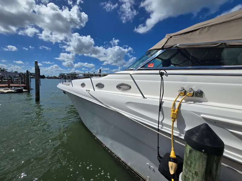 Slide: The Image of 1998 Sea Ray 450 Sundancer docked under blue sky. - 5