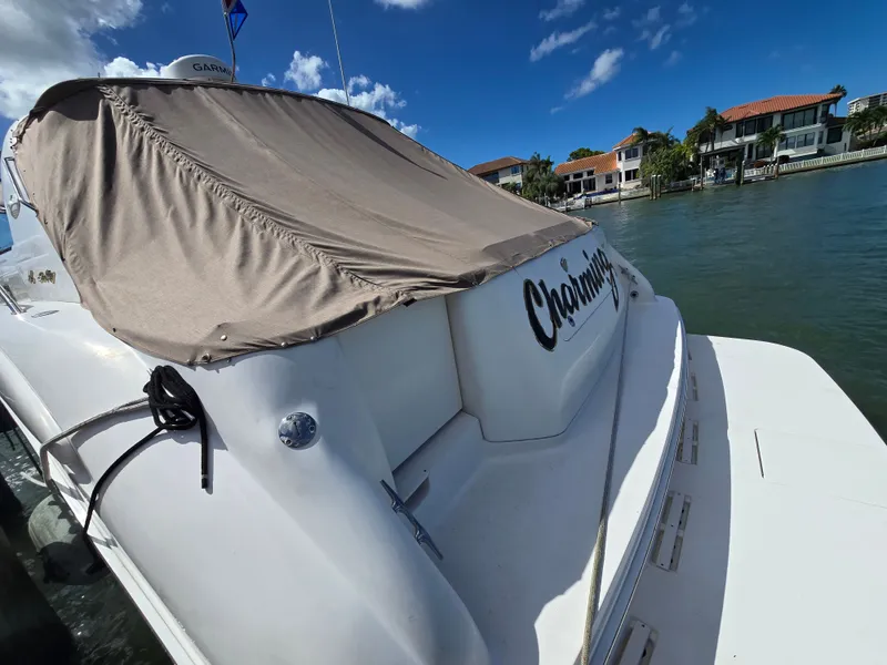 Slide: The Image of 1998 Sea Ray 450 Sundancer docked, covered, sunny day. - 6