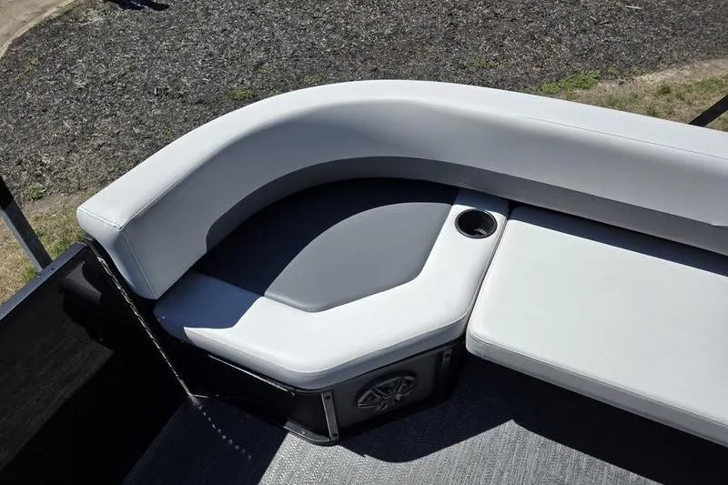 Slide: The Image of 2024 Godfrey Mighty G 1476 C boat seating area with cup holder and speaker. - 10