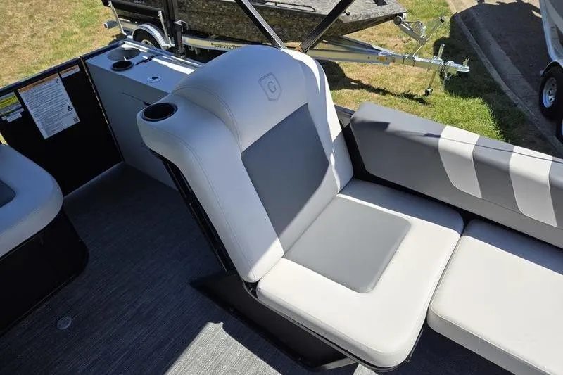 Slide: The Image of 2024 Godfrey Mighty G 1476 C boat interior with gray seating and cup holders. - 11