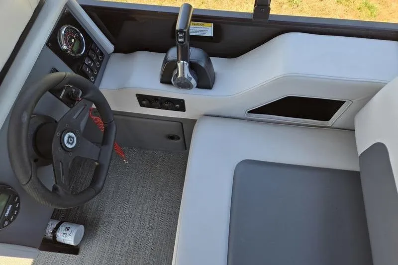 Slide: The Image of 2024 Godfrey Mighty G 1476 C boat cockpit with steering wheel and controls. - 12