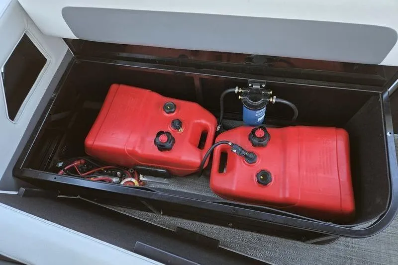 Slide: The Image of Red fuel tanks in a 2024 Godfrey Mighty G 1476 C storage compartment. - 15
