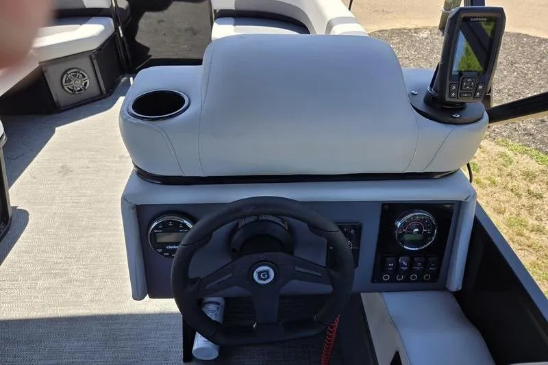 Slide: The Image of 2024 Godfrey Mighty G 1476 C boat dashboard with steering wheel and navigation system. - 16
