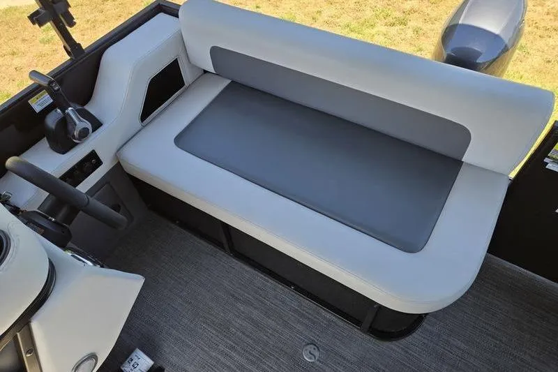 Slide: The Image of Interior of 2024 Godfrey Mighty G 1476 C boat with gray seating and controls. - 18