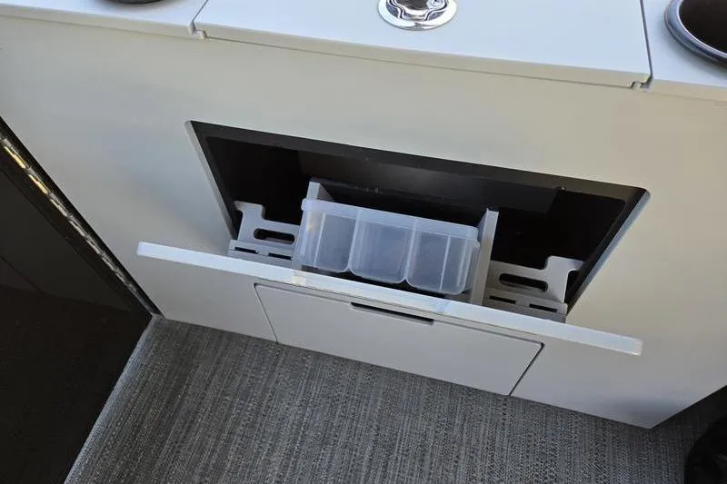 Slide: The Image of Storage compartment in 2024 Godfrey Mighty G 1476 C boat, featuring a pull-out drawer. - 20