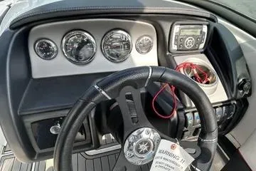 Slide: The Image of Dashboard of a 2019 Bryant 210 boat with steering wheel and gauges. - 4