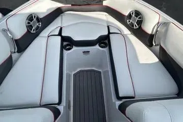 Slide: The Image of 2019 Bryant 210 boat interior with white seating and built-in speakers. - 5