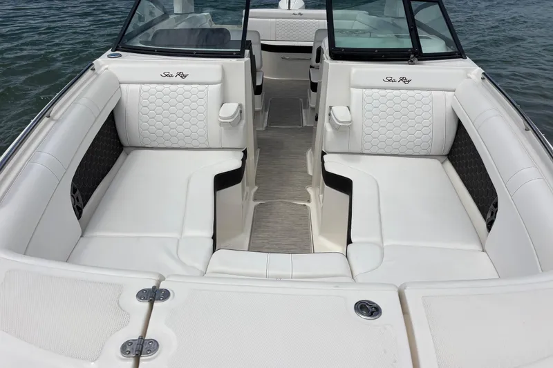 Slide: The Image of 2019 Sea Ray SDX 270 Outboard boat interior with white seating and elegant design. - 13