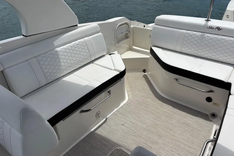 Slide: The Image of 2019 Sea Ray SDX 270 Outboard interior with white seating and water view. - 19