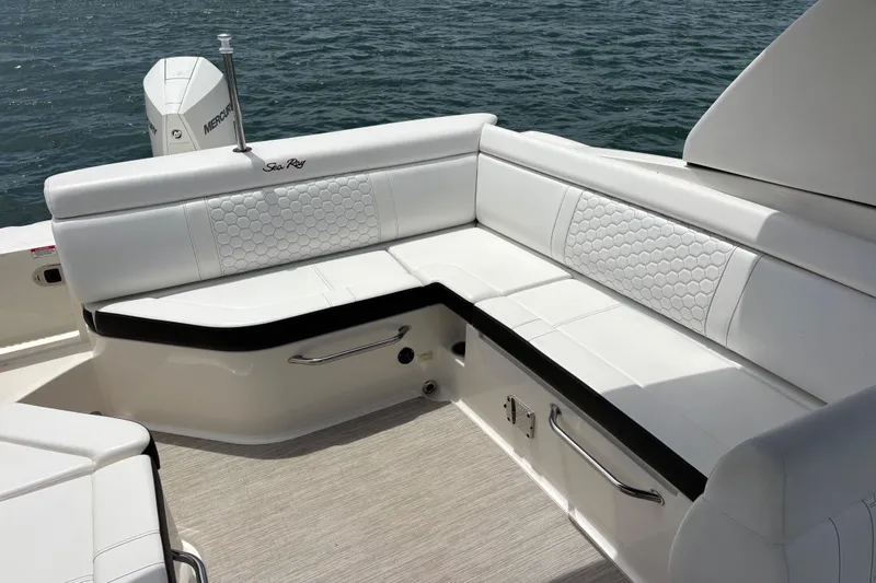 Slide: The Image of 2019 Sea Ray SDX 270 Outboard boat with white seating and water backdrop. - 20