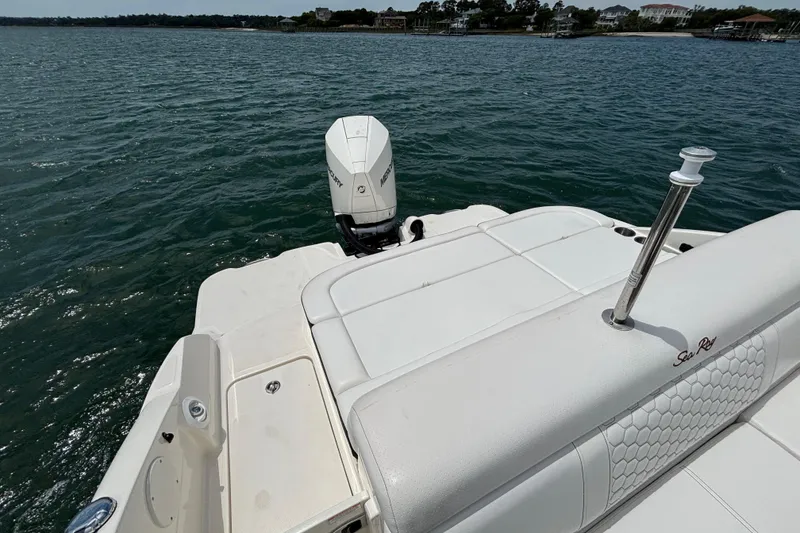 Slide: The Image of 2019 Sea Ray SDX 270 Outboard boat on water, showcasing rear seating and engine. - 22