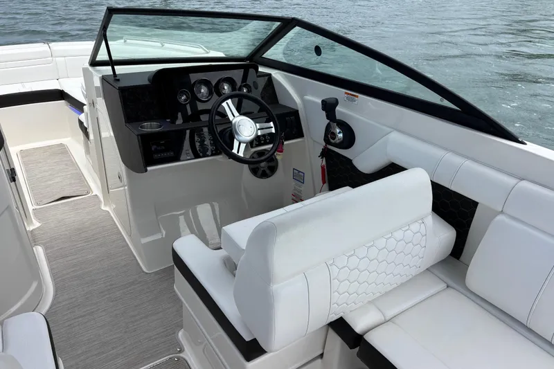 Slide: The Image of 2019 Sea Ray SDX 270 Outboard boat interior with sleek dashboard and comfortable seating. - 23
