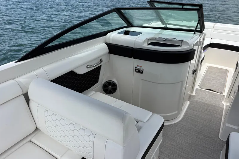 Slide: The Image of 2019 Sea Ray SDX 270 Outboard boat interior with white seating and sleek design. - 24