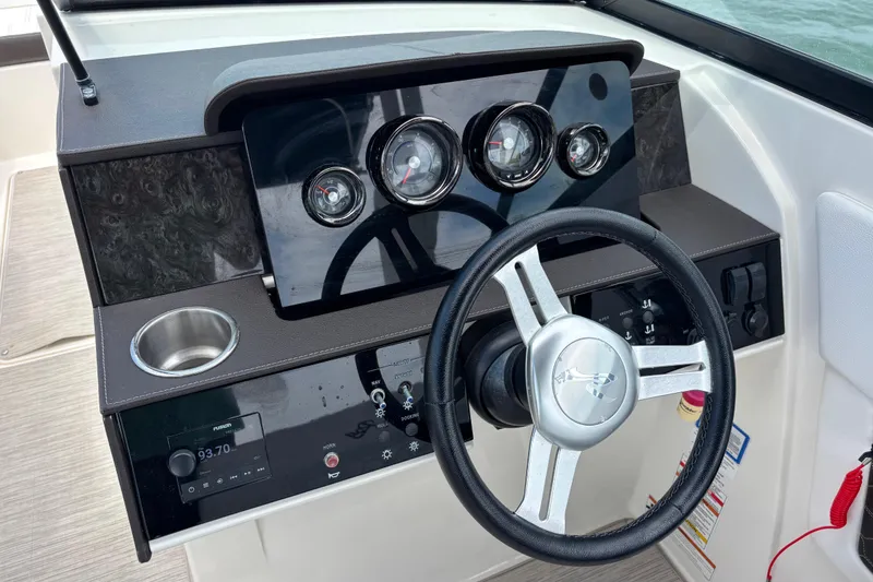 Slide: The Image of 2019 Sea Ray SDX 270 Outboard dashboard with steering wheel and instrument panel. - 26