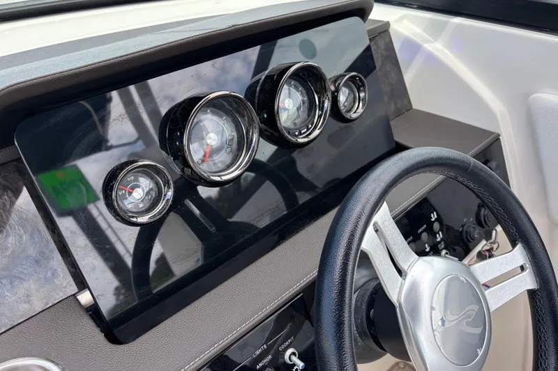 Slide: The Image of Dashboard of 2019 Sea Ray SDX 270 Outboard with gauges and steering wheel. - 27