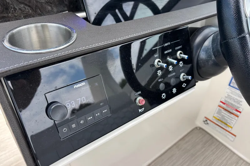 Slide: The Image of Control panel of 2019 Sea Ray SDX 270 Outboard with radio and switches. - 28