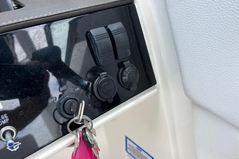 Slide: The Image of Control panel of a 2019 Sea Ray SDX 270 Outboard with ignition keys and switches. - 30