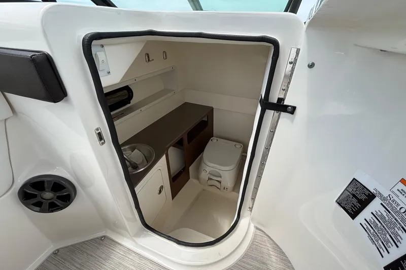 Slide: The Image of Interior of 2019 Sea Ray SDX 270 Outboard boat showing compact bathroom amenities. - 32