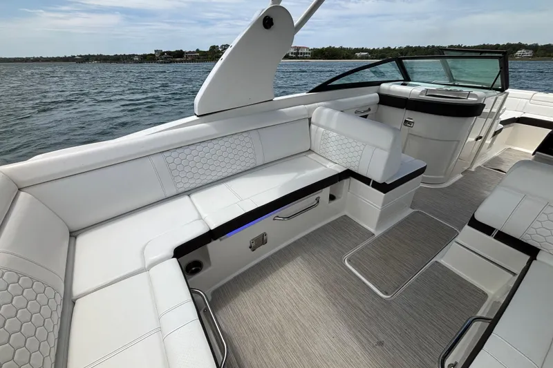 Slide: The Image of 2019 Sea Ray SDX 270 Outboard boat interior with white seating and scenic water view. - 33