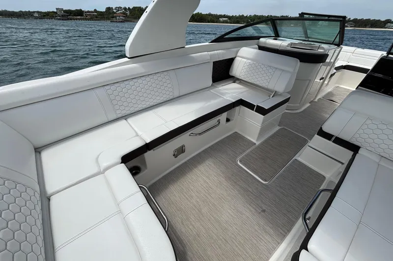 Slide: The Image of 2019 Sea Ray SDX 270 Outboard boat interior with white seating and hexagonal patterns. - 34