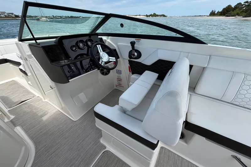 Slide: The Image of 2019 Sea Ray SDX 270 Outboard boat interior with sleek dashboard and comfortable seating. - 35