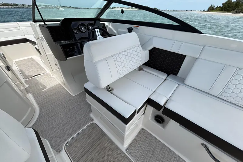 Slide: The Image of 2019 Sea Ray SDX 270 Outboard interior with white seating and modern dashboard. - 37