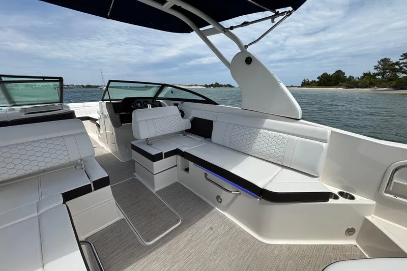 Slide: The Image of 2019 Sea Ray SDX 270 Outboard boat interior with white seating and scenic water view. - 38