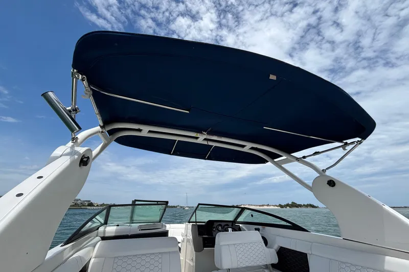 Slide: The Image of 2019 Sea Ray SDX 270 Outboard boat with blue canopy on open water. - 39