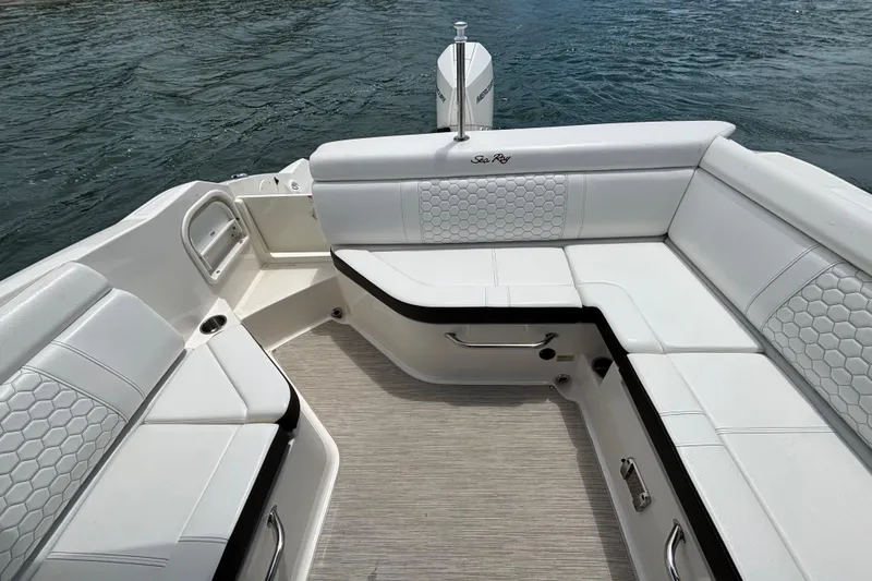 Slide: The Image of 2019 Sea Ray SDX 270 Outboard boat interior with white cushioned seating on water. - 40
