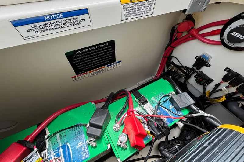 Slide: The Image of Battery compartment of 2019 Sea Ray SDX 270 Outboard with wiring and safety notices. - 41