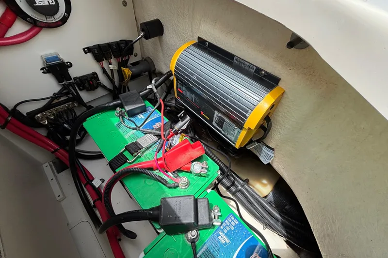 Slide: The Image of Battery compartment of a 2019 Sea Ray SDX 270 Outboard with wiring and charger. - 42