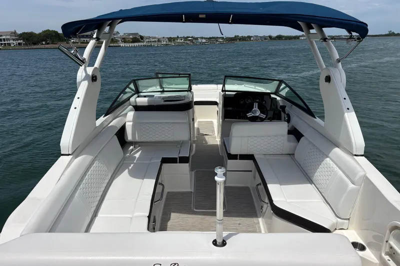 Slide: The Image of 2019 Sea Ray SDX 270 Outboard boat with spacious seating and blue canopy on the water. - 44