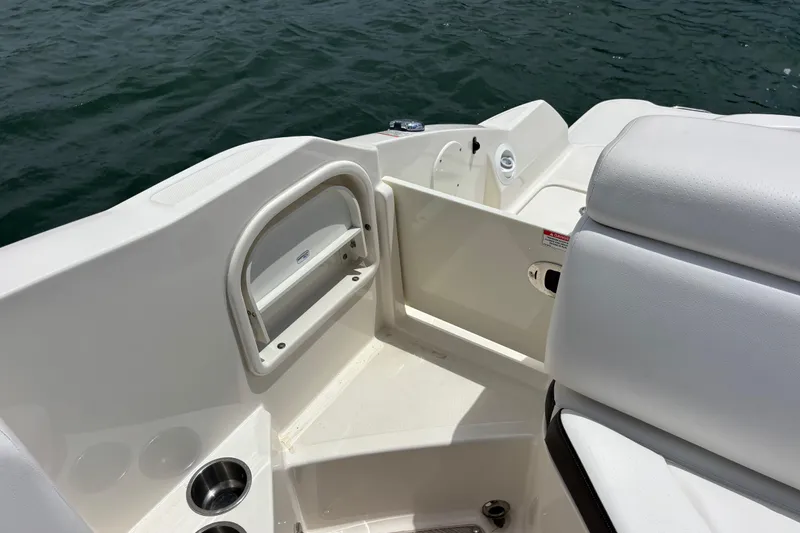 Slide: The Image of 2019 Sea Ray SDX 270 Outboard boat interior with seating and cup holders. - 45