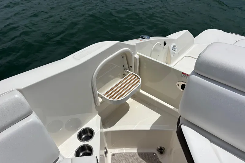 Slide: The Image of 2019 Sea Ray SDX 270 Outboard boat interior with seating and cup holders. - 46