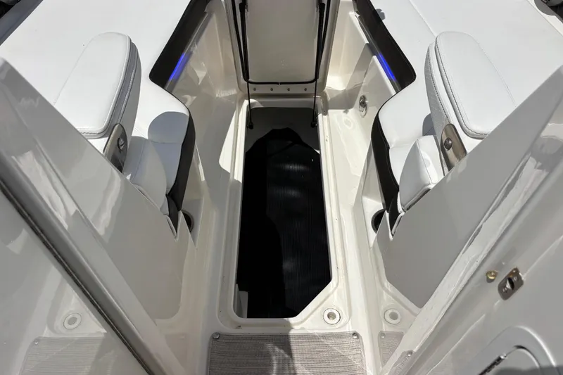 Slide: The Image of 2019 Sea Ray SDX 270 Outboard interior with white seating and storage compartment. - 52