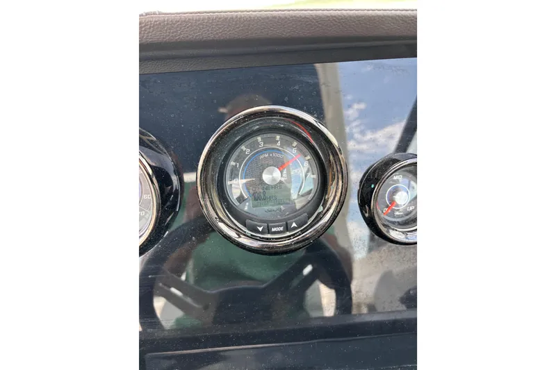 Slide: The Image of Dashboard gauges of a 2019 Sea Ray SDX 270 Outboard boat. - 53