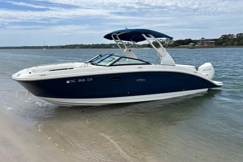 Slide: The Image of 2019 Sea Ray SDX 270 Outboard boat on sandy shore with blue water background. - 8