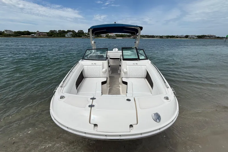 Slide: The Image of 2019 Sea Ray SDX 270 Outboard boat docked on calm water, showcasing spacious seating. - 9